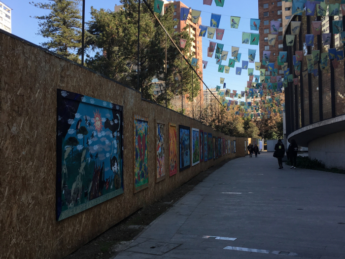 murals and hanging signs along pathway to museum